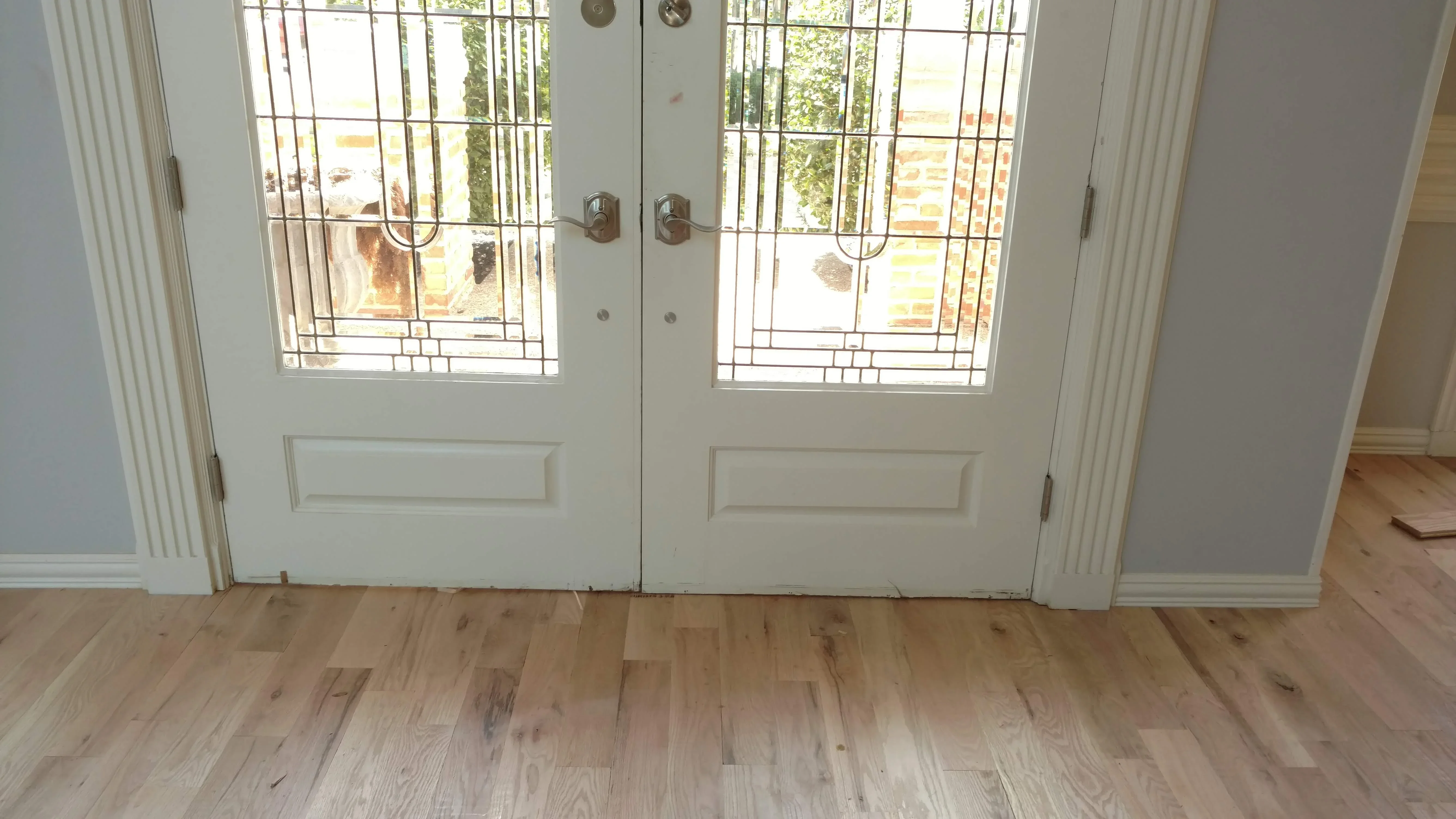 White French doors with geometric leaded glass panels and brushed nickel hardware
