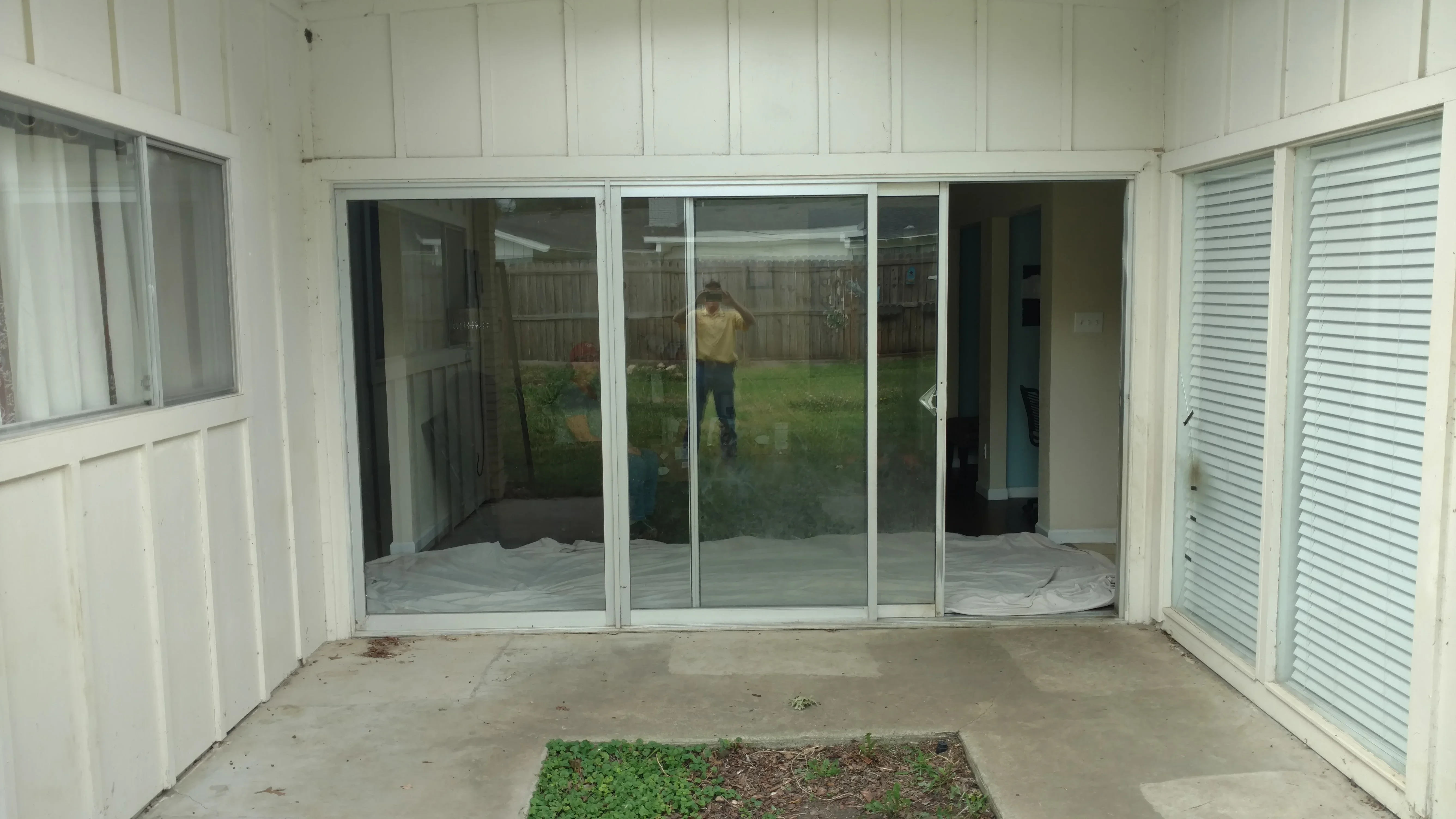 Multi-panel sliding glass door with aluminum frame in white patio enclosure