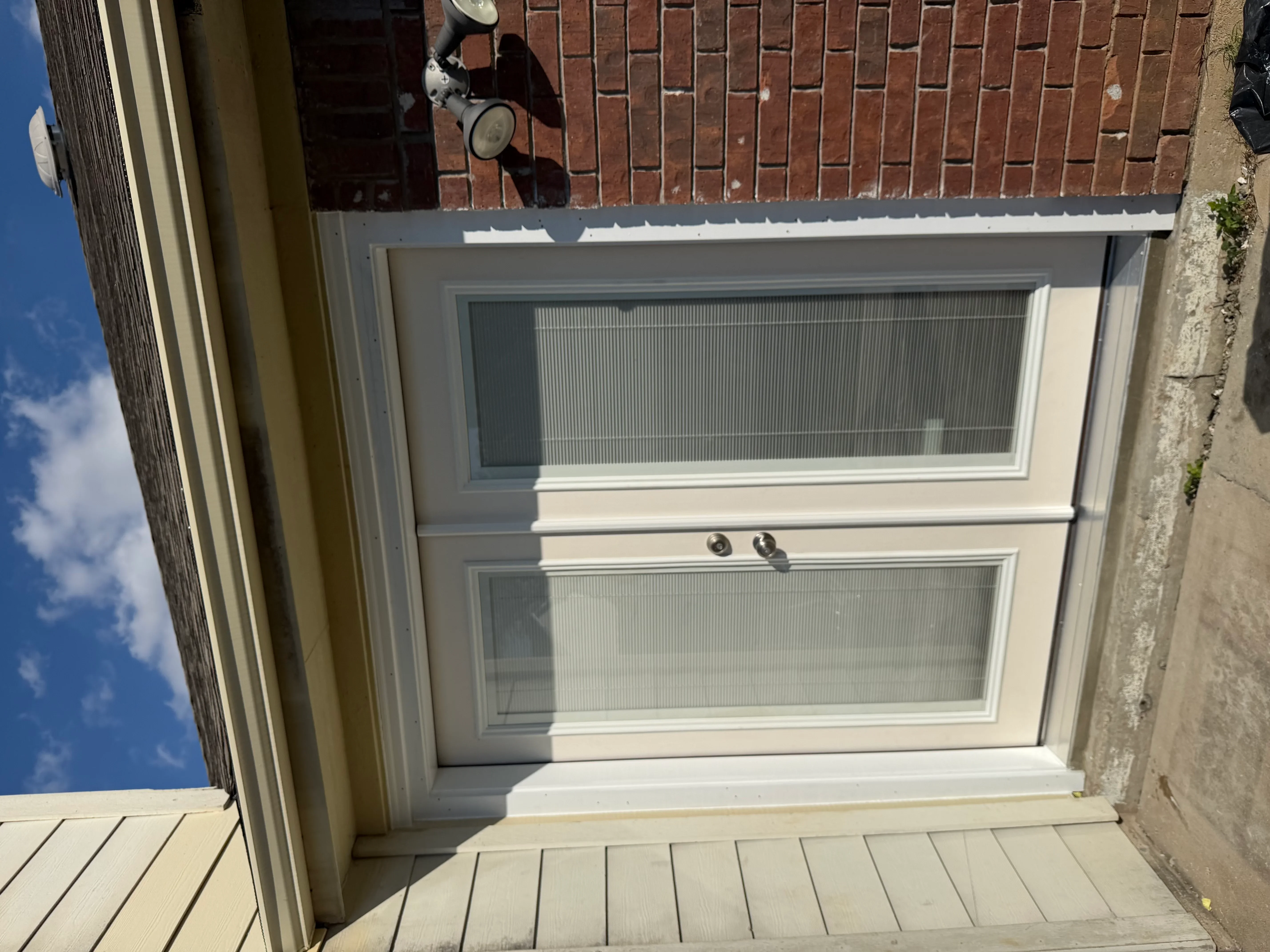 White French door with two glass panels and integrated blinds, chrome hardware, residential installation